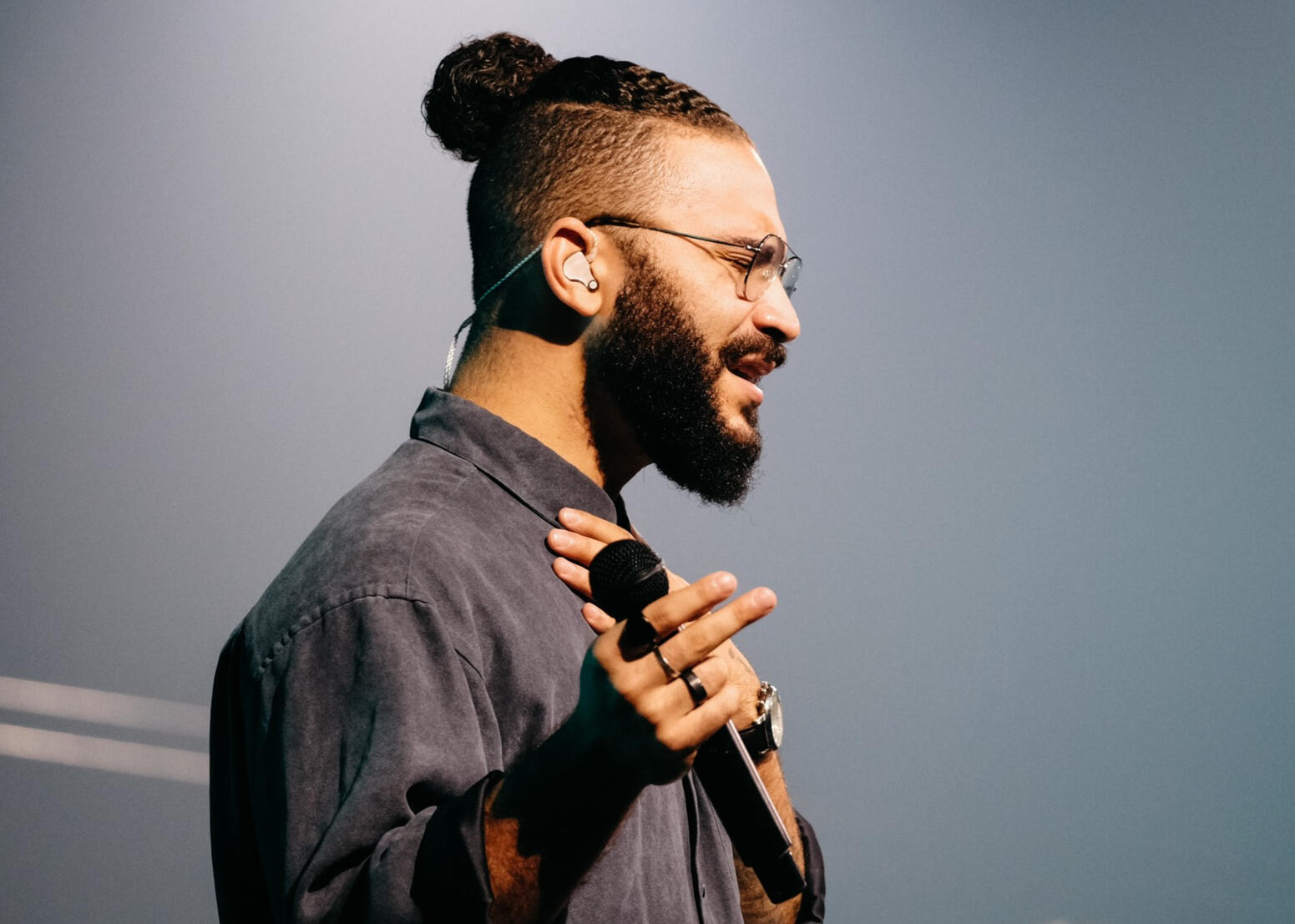 a man holding a microphone with his eyes closed