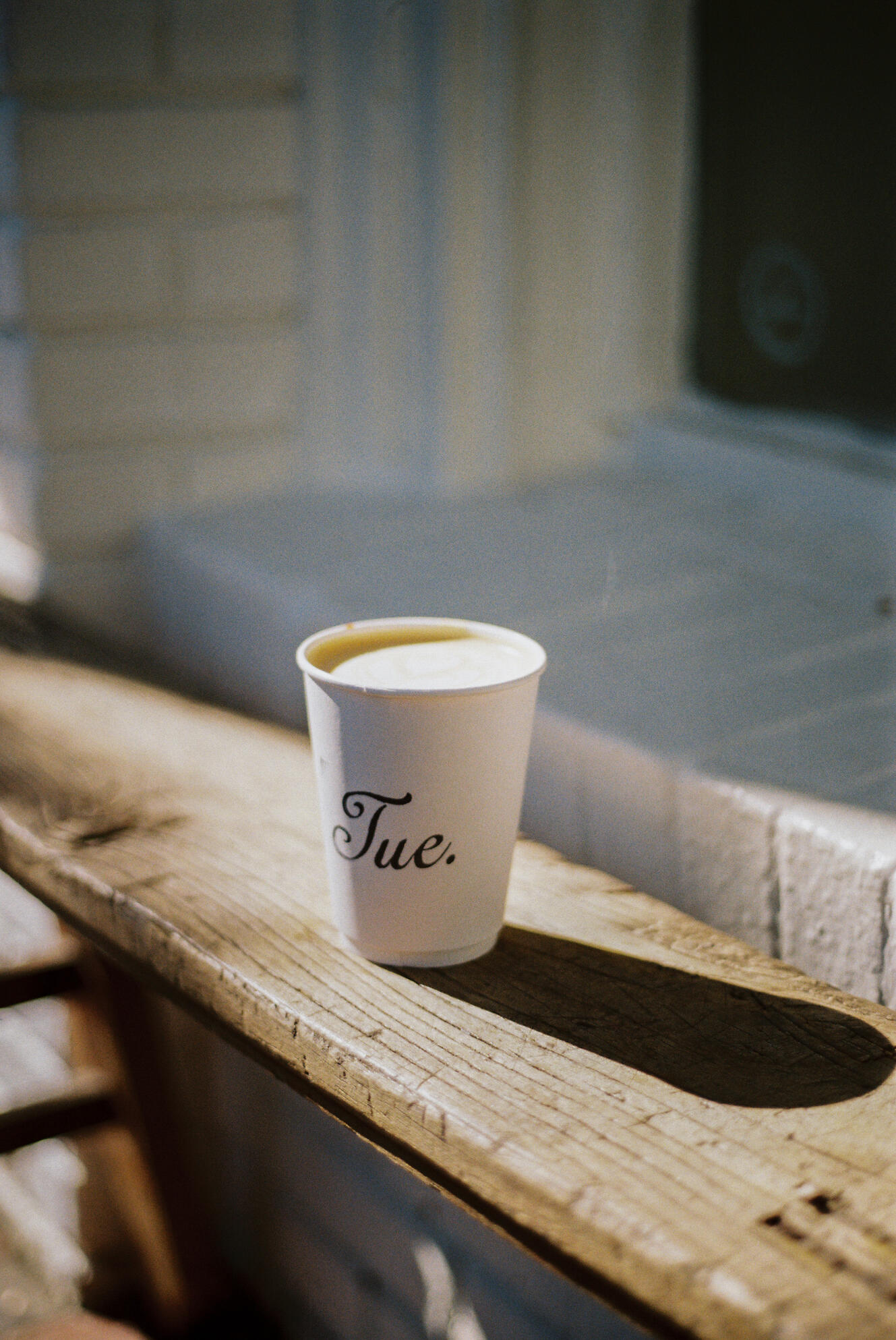 a cup of coffee on a bench