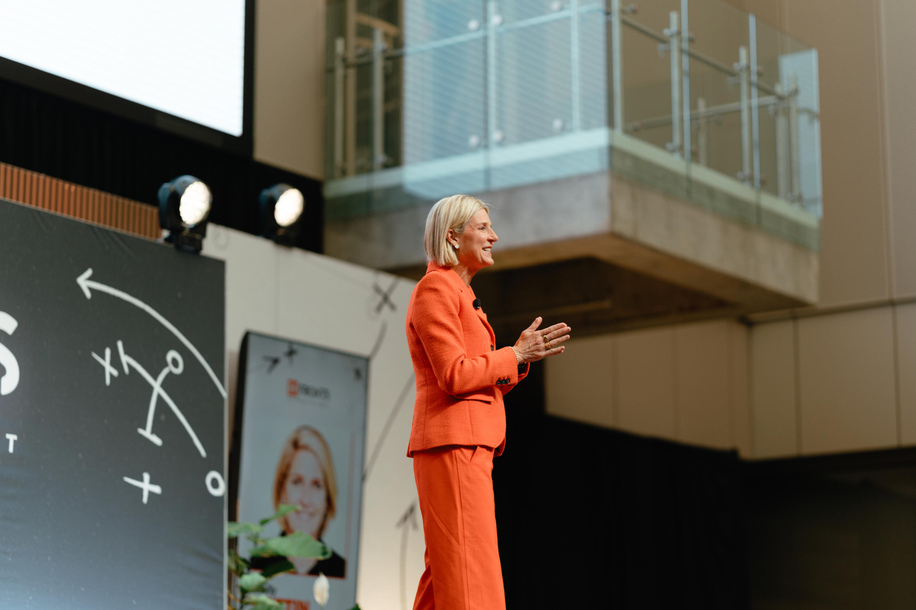indoor conference Molly battin on stage in a conference venue